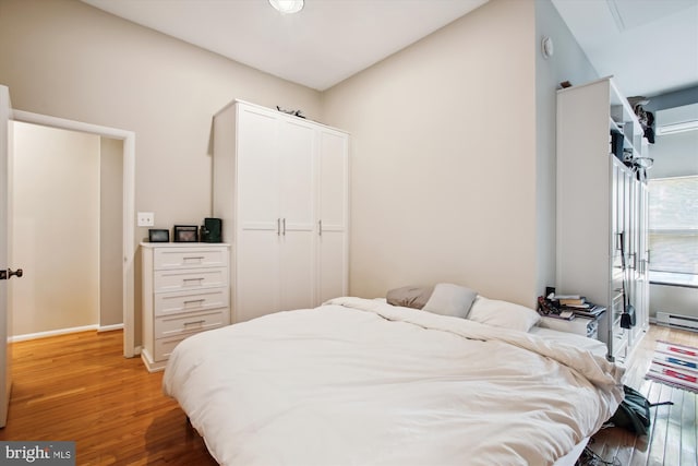 2117 N St NW Unit 2, Washington, DC 20037 - bedroom with light wood finished floors and a baseboard radiator