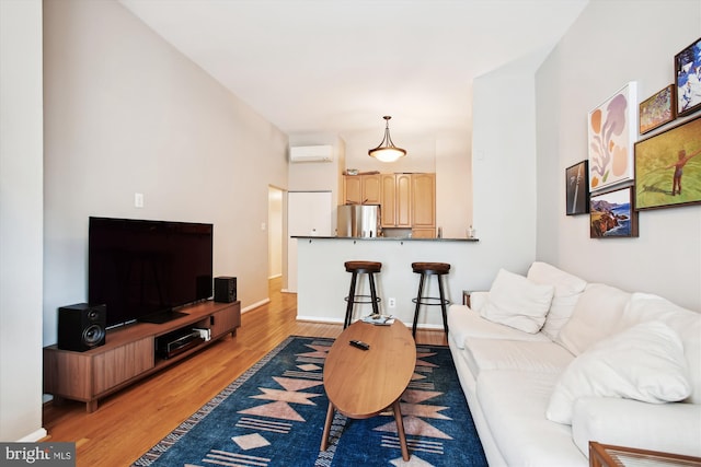 2117 N St NW Unit 2, Washington, DC 20037 - living room with light wood-style flooring and a wall mounted air conditioner
