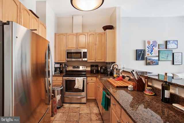 2117 N St NW Unit 2, Washington, DC 20037 - kitchen featuring appliances with stainless steel finishes, light brown cabinets, and dark stone counters