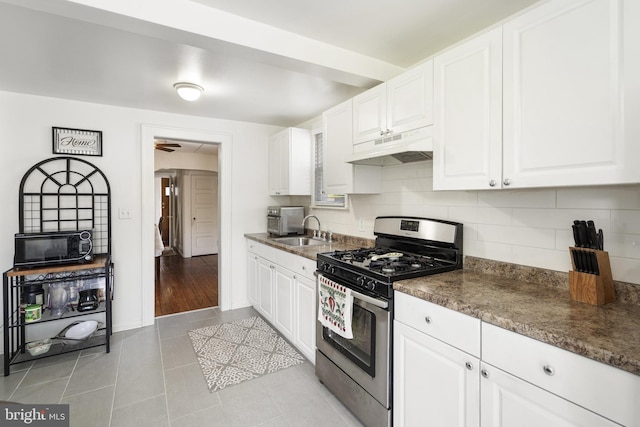 53 Ackerman Ave, Saddle Brook, NJ 07663 - kitchen with gas stove, under cabinet range hood, black microwave, and white cabinetry