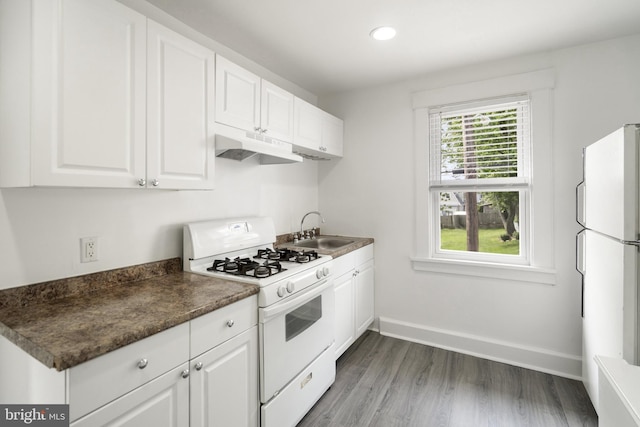 53 Ackerman Ave, Saddle Brook, NJ 07663 - kitchen featuring white appliances, under cabinet range hood, white cabinetry, dark countertops, and wood finished floors