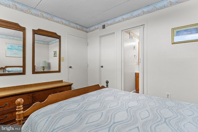 4709 Coastal Hwy Unit 460, Ocean City, MD 21842 - bedroom with a textured ceiling and ensuite bath