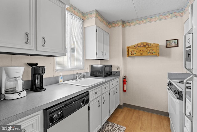 4709 Coastal Hwy Unit 460, Ocean City, MD 21842 - kitchen with dishwasher, black microwave, white electric stove, light wood-style flooring, and light countertops