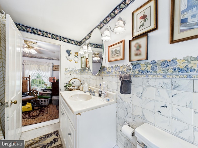 12194 Knife Box Rd, Greensboro, MD 21639 - bathroom featuring vanity, tile walls, tile patterned floors, a wainscoted wall, and ceiling fan