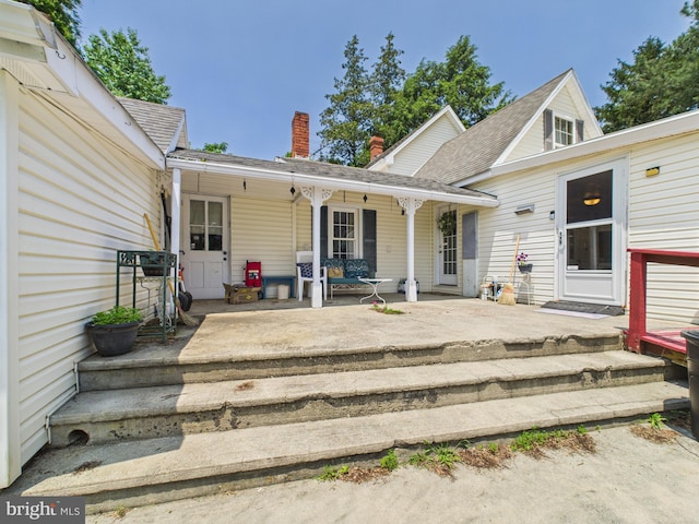 12194 Knife Box Rd, Greensboro, MD 21639 - exterior space with a porch and a chimney