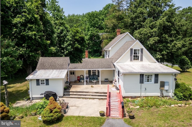 12194 Knife Box Rd, Greensboro, MD 21639 - view of front facade with a chimney, stairway, a patio area, and concrete driveway