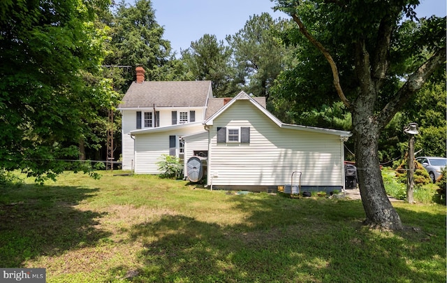 12194 Knife Box Rd, Greensboro, MD 21639 - back of house with a lawn, a chimney, and view of wooded area