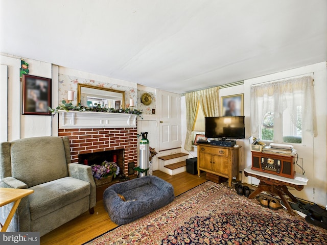 12194 Knife Box Rd, Greensboro, MD 21639 - living room with wood finished floors, a fireplace, and wallpapered walls