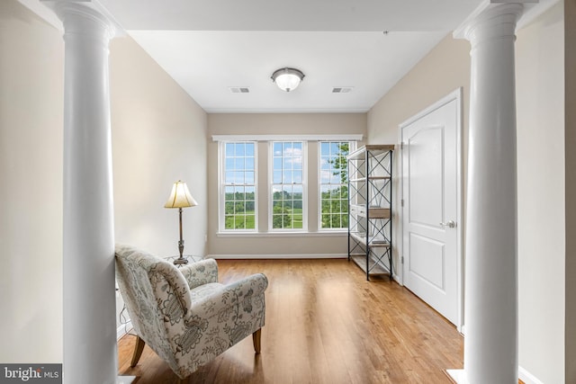 7315 Brookview Rd Unit 306, Elkridge, MD 21075 - living area with decorative columns and light wood-style floors
