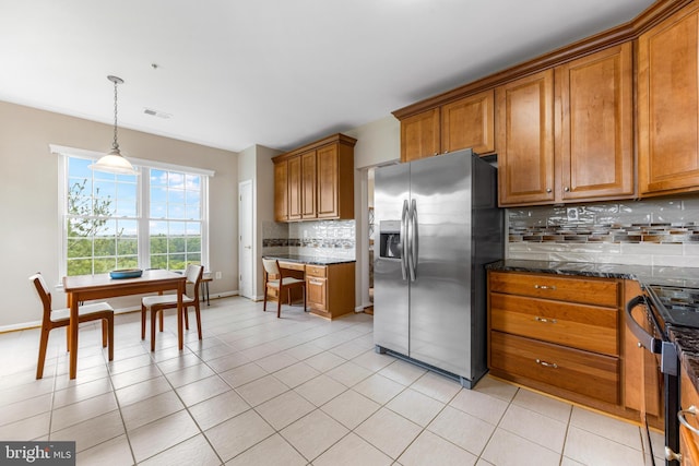 7315 Brookview Rd Unit 306, Elkridge, MD 21075 - kitchen with stainless steel refrigerator with ice dispenser, brown cabinetry, black stove, tasteful backsplash, and pendant lighting