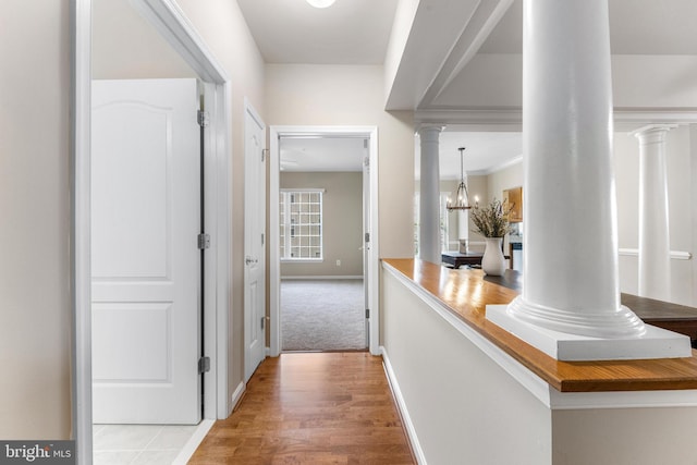 7315 Brookview Rd Unit 306, Elkridge, MD 21075 - hall with ornate columns, light wood-type flooring, and a chandelier