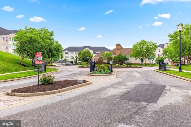 7315 Brookview Rd Unit 306, Elkridge, MD 21075 - view of asphalt street with a residential view, street lights, curbs, and traffic signs
