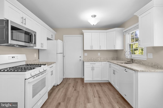 203 Watts Branch Pkwy, Rockville, MD 20850 - kitchen featuring white appliances, light wood-type flooring, and white cabinets