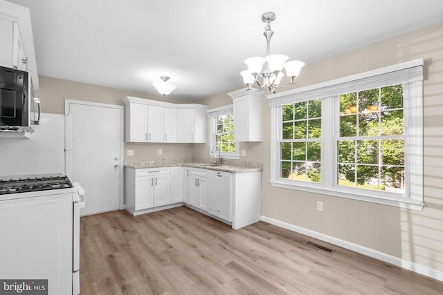 203 Watts Branch Pkwy, Rockville, MD 20850 - kitchen featuring white appliances, a chandelier, and light wood-style flooring