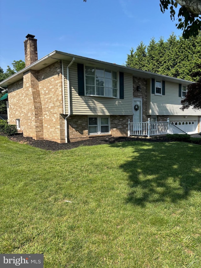 3332 Groton Ln, Dover, PA 17315 - view of front facade featuring a chimney, a front yard, and brick siding