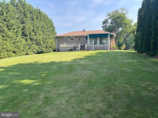 3332 Groton Ln, Dover, PA 17315 - rear view of property with a chimney, brick siding, a yard, and a wooden deck