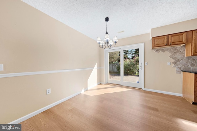 43 Walnut St, Little Egg Harbor Twp, NJ 08087 - unfurnished dining area with a chandelier, light wood-style floors, and a textured ceiling