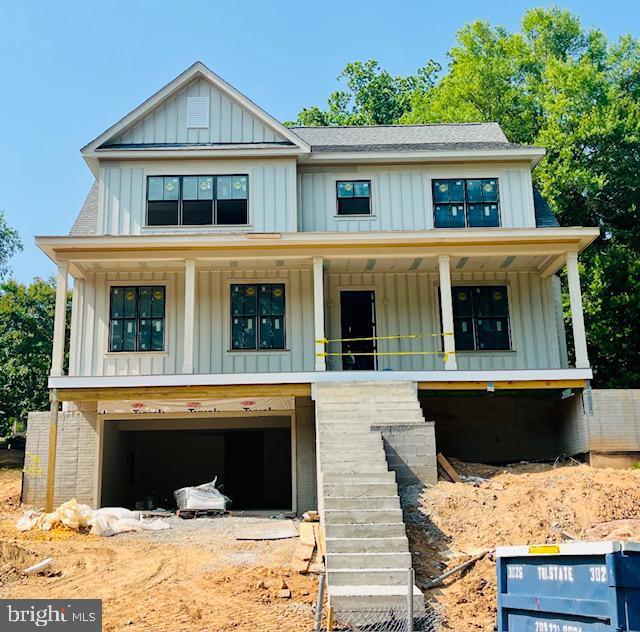 2541 23rd Rd N, Arlington, VA 22207 - view of front of property featuring board and batten siding, a porch, stairs, and an attached garage