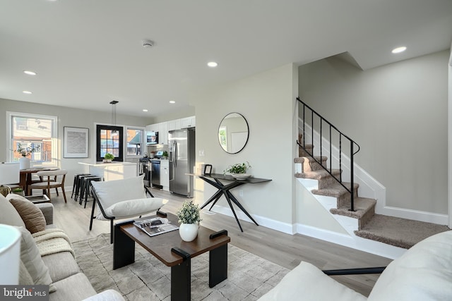 3027 Seamon Ave, Baltimore, MD 21225 - living room featuring light wood-style flooring, stairway, and recessed lighting
