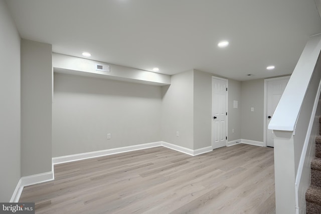 3027 Seamon Ave, Baltimore, MD 21225 - finished basement with light wood-style flooring, recessed lighting, and stairway