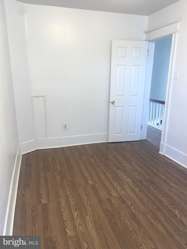 1921 S Ithan St, Philadelphia, PA 19143 - spare room featuring dark wood finished floors and baseboards
