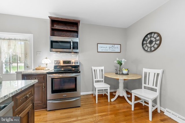 18 Linda Ln, Hatboro, PA 19040 - kitchen featuring appliances with stainless steel finishes, a baseboard heating unit, light stone counters, light wood finished floors, and dark brown cabinets