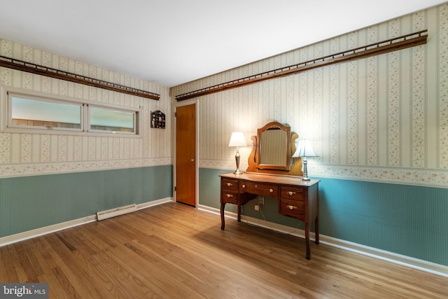 18 Linda Ln, Hatboro, PA 19040 - bedroom with wallpapered walls, wood finished floors, baseboard heating, and a wainscoted wall