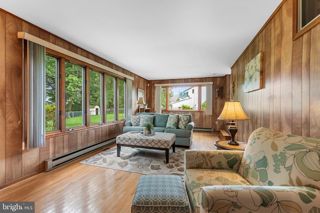 18 Linda Ln, Hatboro, PA 19040 - living room featuring a baseboard heating unit, wooden walls, and light wood-style flooring