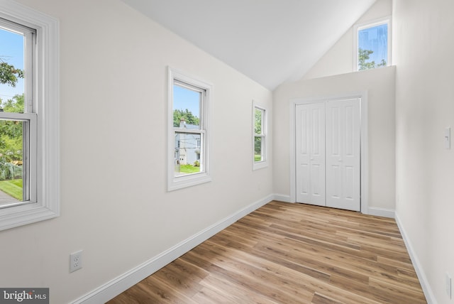 33 Main St, Pilesgrove, NJ 08098 - unfurnished bedroom with multiple windows, light wood finished floors, a closet, and high vaulted ceiling