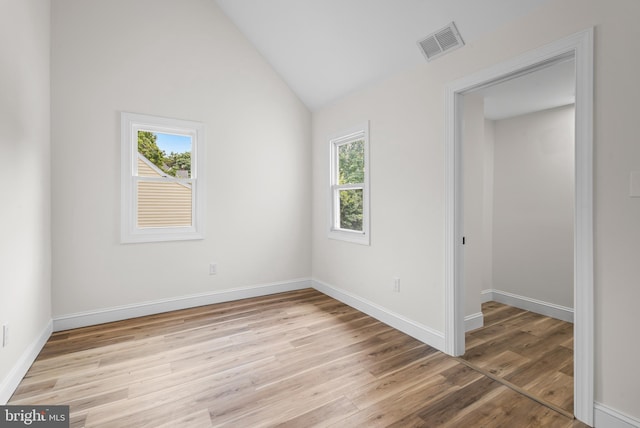 33 Main St, Pilesgrove, NJ 08098 - empty room featuring healthy amount of natural light, light wood finished floors, and vaulted ceiling