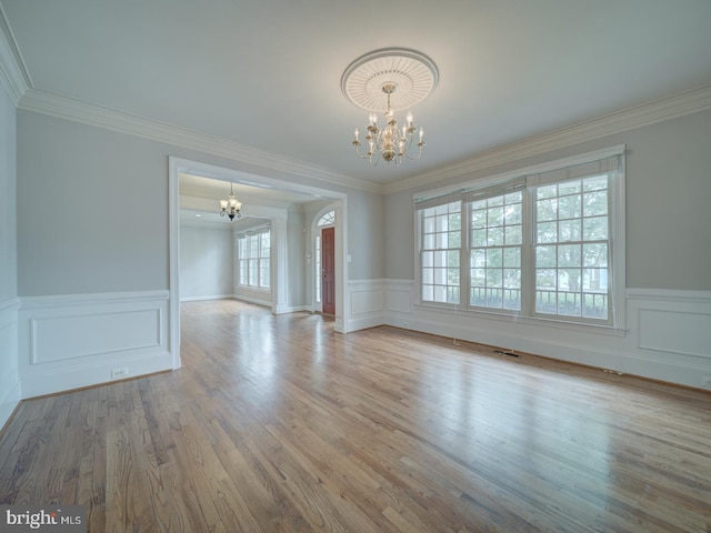 8429 Link Hills Loop, Gainesville, VA 20155 - spare room with a chandelier, wainscoting, ornamental molding, wood finished floors, and a decorative wall