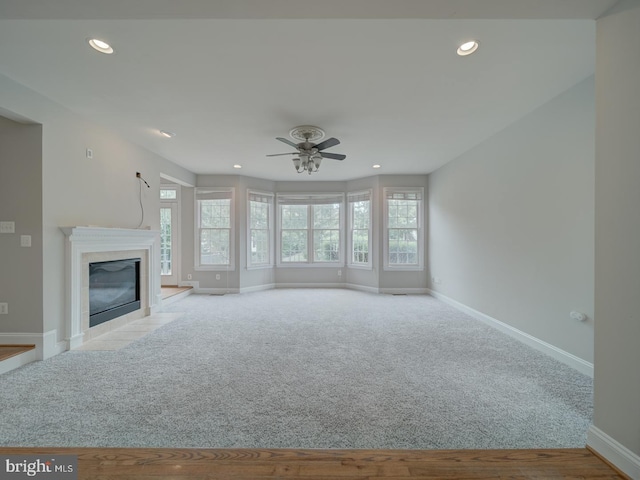 8429 Link Hills Loop, Gainesville, VA 20155 - unfurnished living room with carpet, a ceiling fan, a tile fireplace, and recessed lighting