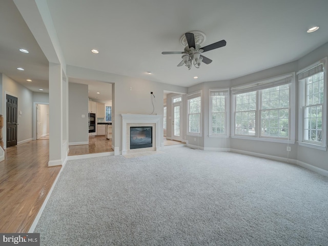 8429 Link Hills Loop, Gainesville, VA 20155 - unfurnished living room featuring plenty of natural light, a ceiling fan, recessed lighting, a fireplace, and light wood-style floors