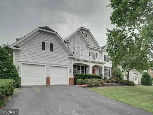 8429 Link Hills Loop, Gainesville, VA 20155 - view of front of property featuring asphalt driveway, a balcony, a front yard, and a garage