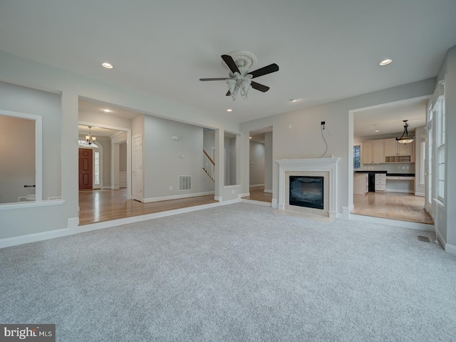 8429 Link Hills Loop, Gainesville, VA 20155 - unfurnished living room featuring light carpet, recessed lighting, a ceiling fan, a fireplace with flush hearth, and stairway