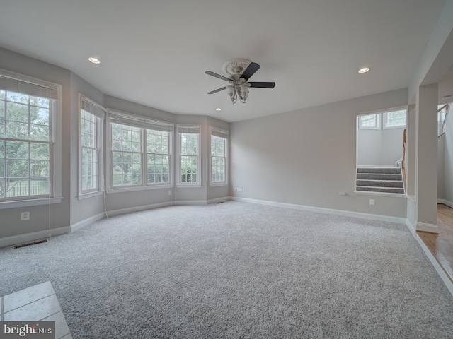8429 Link Hills Loop, Gainesville, VA 20155 - unfurnished room featuring healthy amount of natural light, ceiling fan, stairway, carpet flooring, and recessed lighting