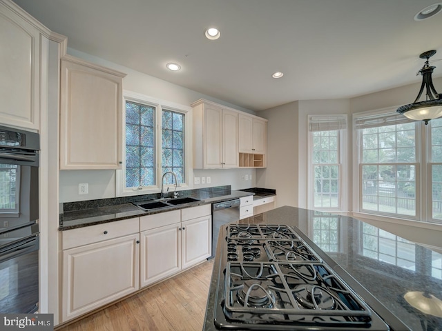 8429 Link Hills Loop, Gainesville, VA 20155 - kitchen with black appliances, light wood-style flooring, recessed lighting, dark stone counters, and decorative light fixtures