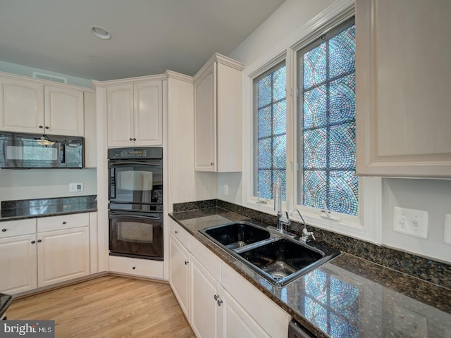 8429 Link Hills Loop, Gainesville, VA 20155 - kitchen featuring black appliances, dark stone countertops, and light wood-type flooring