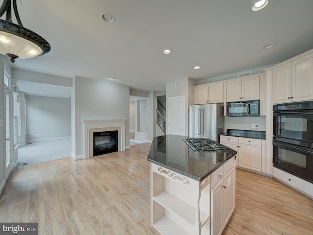 8429 Link Hills Loop, Gainesville, VA 20155 - kitchen with black appliances, open shelves, a center island, a glass covered fireplace, and dark stone counters