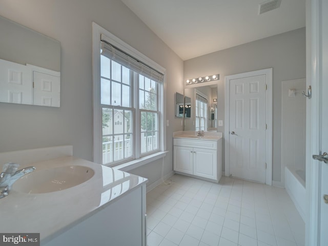 8429 Link Hills Loop, Gainesville, VA 20155 - full bathroom featuring two vanities, tile patterned floors, and washtub / shower combination