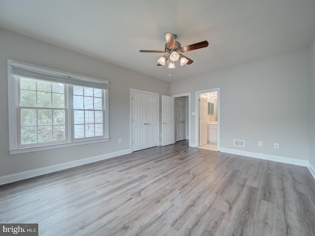8429 Link Hills Loop, Gainesville, VA 20155 - unfurnished bedroom with wood finished floors, connected bathroom, and ceiling fan