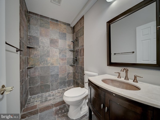 8429 Link Hills Loop, Gainesville, VA 20155 - bathroom with vanity, a tile shower, and stone finish flooring