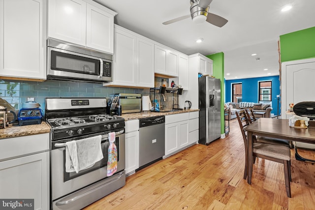 206 Fernon St, Philadelphia, PA 19148 - kitchen featuring stainless steel appliances, white cabinets, light wood-style flooring, a ceiling fan, and tasteful backsplash