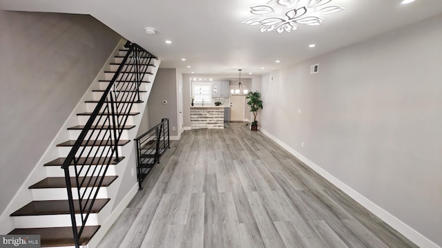 2702 S Marshall St, Philadelphia, PA 19148 - hall with recessed lighting, light wood-style floors, a chandelier, and stairs