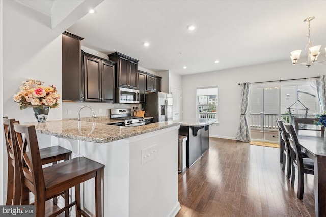 515 Quarry Point Rd, Malvern, PA 19355 - kitchen featuring stainless steel appliances, a chandelier, a kitchen breakfast bar, light stone countertops, and recessed lighting