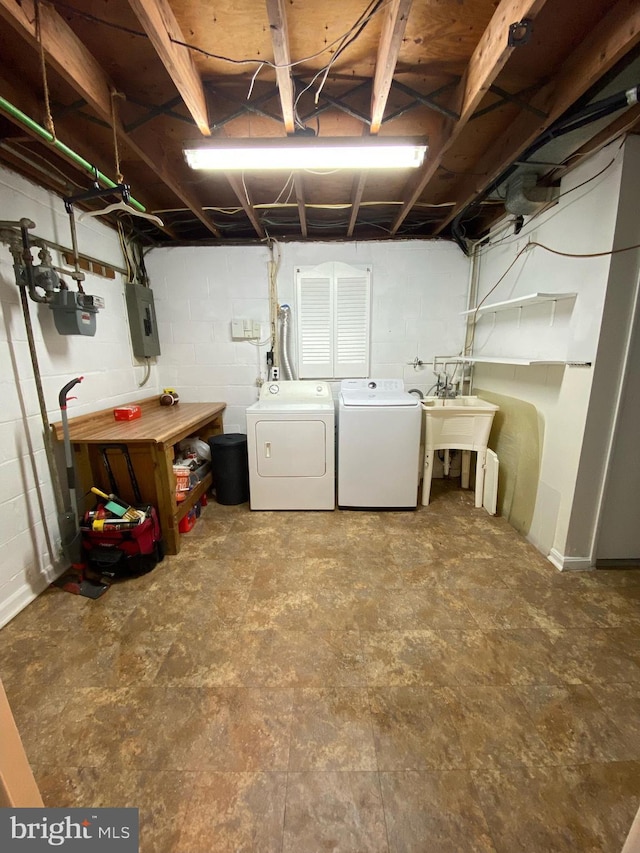 6313 Bardu Ave, Springfield, VA 22152 - unfinished below grade area featuring washing machine and clothes dryer, electric panel, and concrete block wall