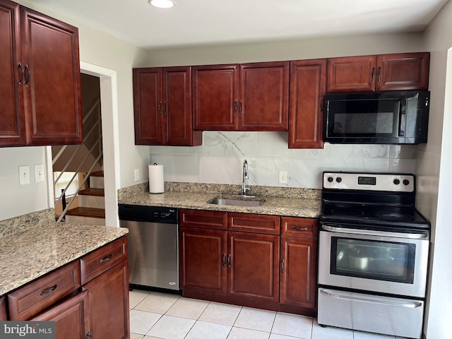 6313 Bardu Ave, Springfield, VA 22152 - kitchen with appliances with stainless steel finishes, dark brown cabinets, light stone countertops, decorative backsplash, and recessed lighting