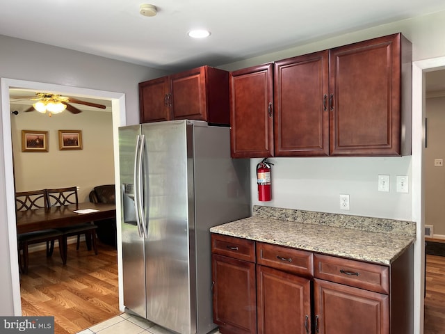 6313 Bardu Ave, Springfield, VA 22152 - kitchen with stainless steel fridge, ceiling fan, dark brown cabinets, light stone countertops, and recessed lighting