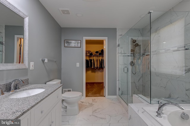 2018 Silver Bell Ct, Culpeper, VA 22701 - bathroom featuring marble finish flooring, vanity, a marble finish shower, a garden tub, and a walk in closet