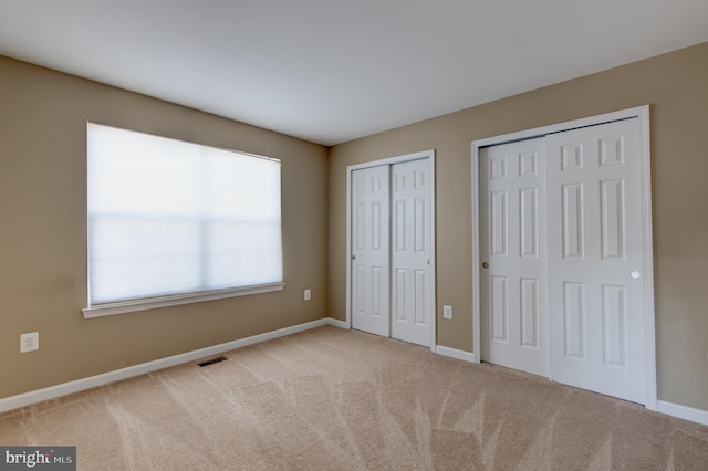 2018 Silver Bell Ct, Culpeper, VA 22701 - unfurnished bedroom featuring two closets and carpet flooring